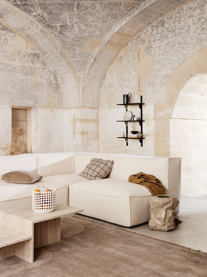 Ferm Living's white Ceramic basket in a living room.