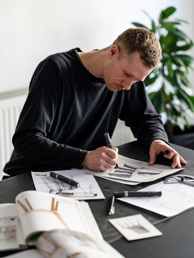David Geckeler sitting at his drawing board sketching.