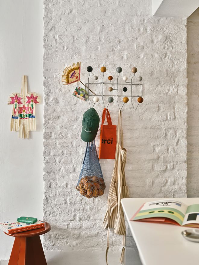 Hang it all coat rack against a white brick wall