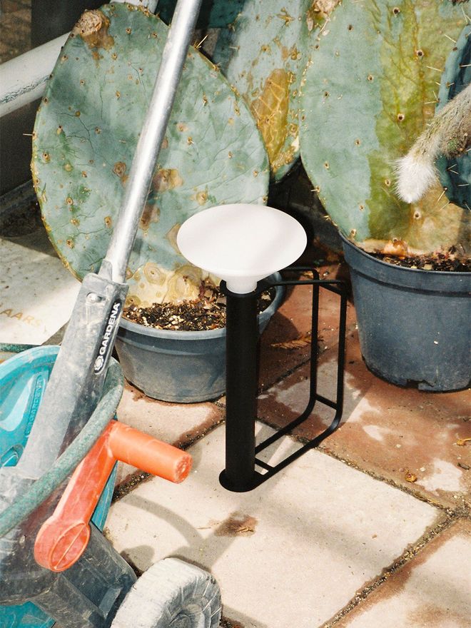 Muuto's Piton portable lamp in the garden.