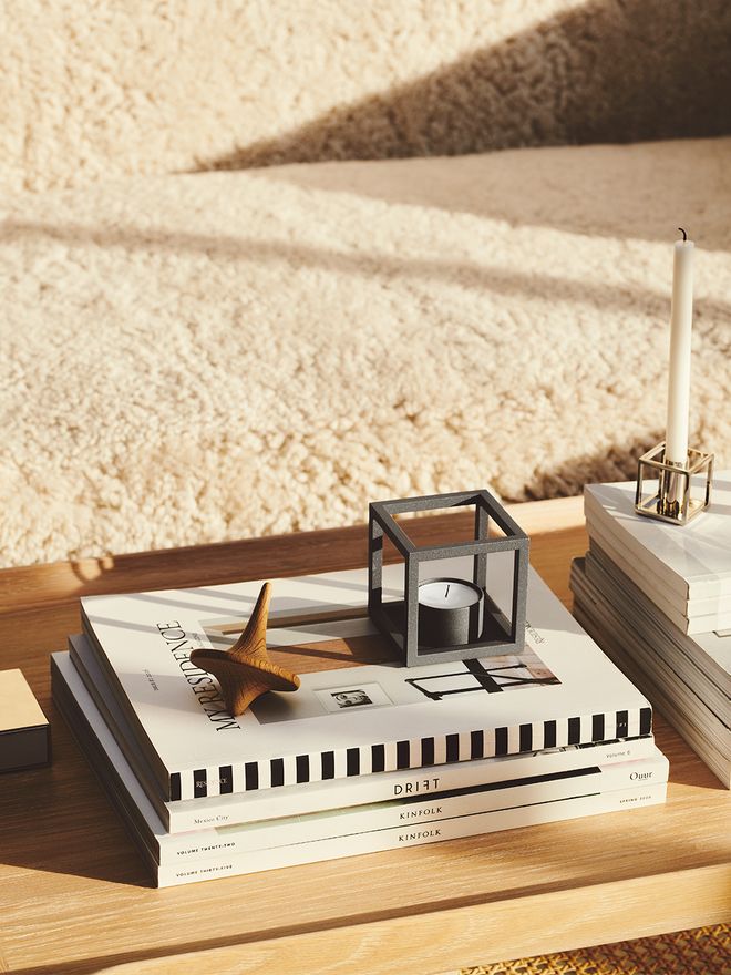 An image featuring the Kubus T candleholder and Kubus 1 candleholder on a coffee table as part of the living room decor.