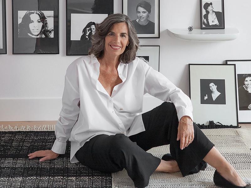 Designer Nani Marquina sitting on the floor inside her home