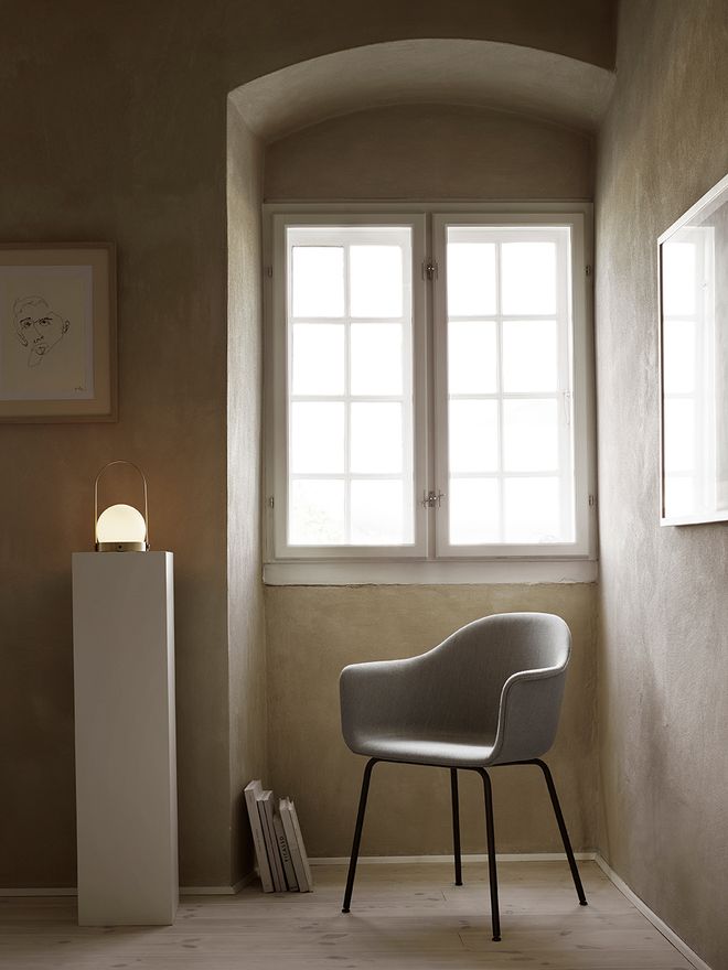 The Carrie lamp by Menu in a reading nook.