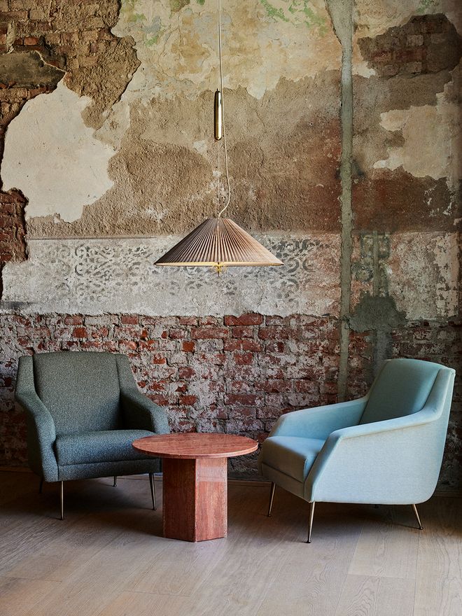 An image featuring GUBI's Paavo Tynell's 1967 lamp as part of the living room interior.