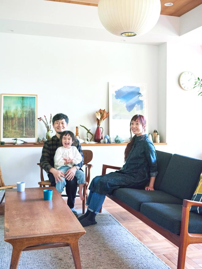 Family sitting and smiling in a living room