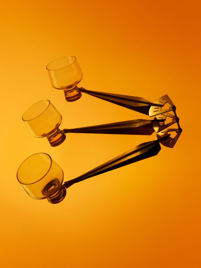 Iittala’s yellow Solare glasses photographed against an orange background