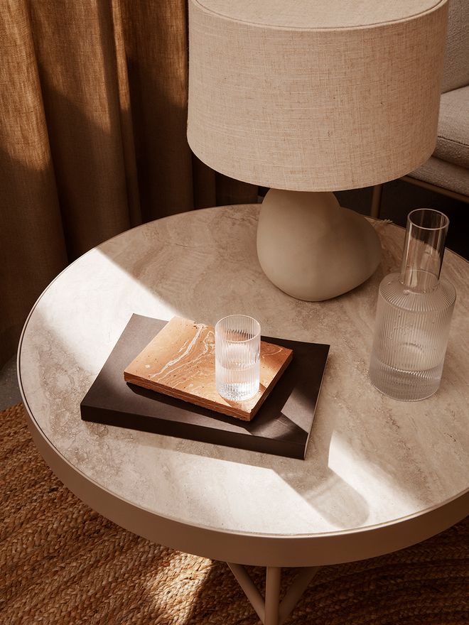 An image of Ferm Living's Travertine Side Table from above. 