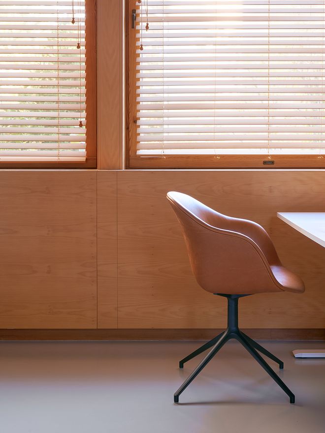 A detail of a chair next to a desk. 