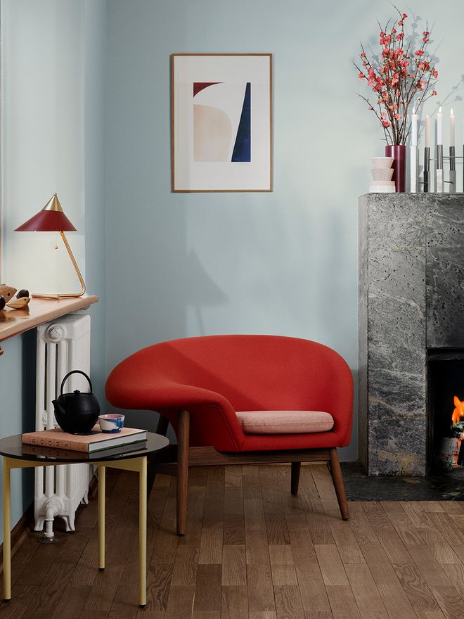 Warm Nordic's Fried Egg chair and Brass Top table lamp in a living room setting.