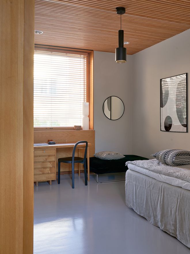 A room view with a desk and a bed