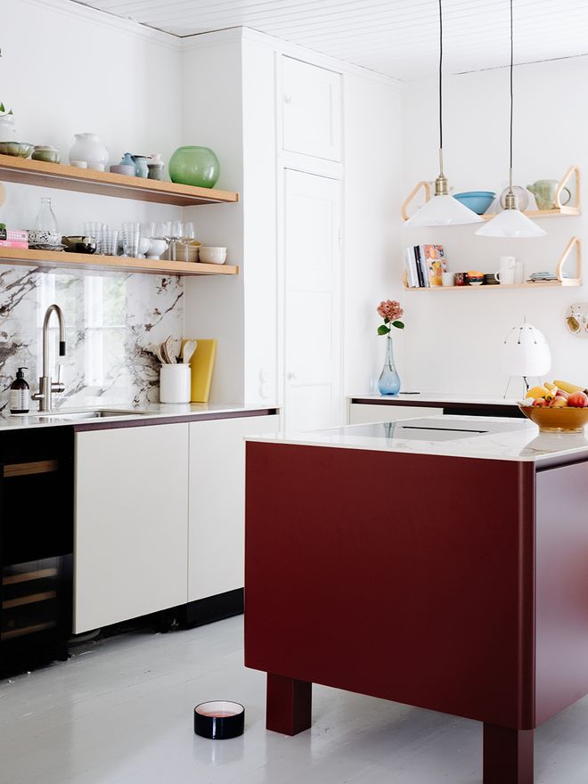 Kitchen with a quartz countertop and a red island