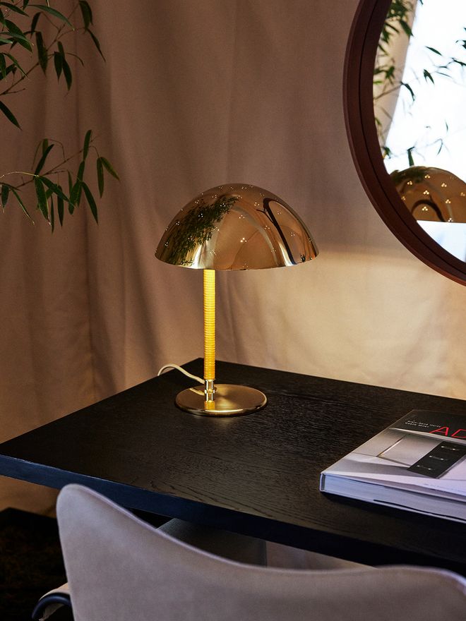 An image featuring GUBI's Paavo Tynell's 9209 table lamp as part of the living room interior.