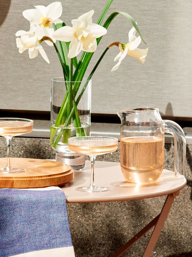 An image of Ferm Living's Ripple champagne glasses on a table.