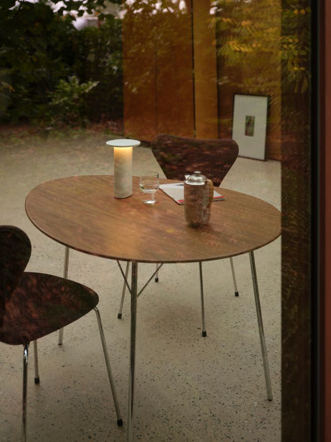 A portable Solae lamp placed on a table on the terrace