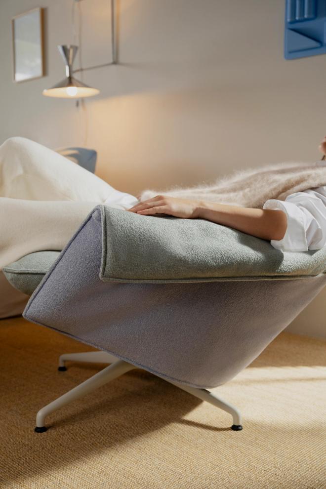 A person reclining in a Bascule lounge chair