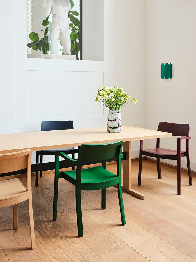 HAY Pastis chairs in various colours around a wooden Passerelle dining table