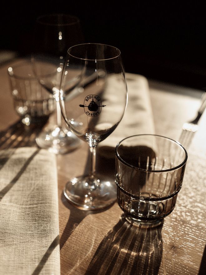 A close-up of a wine glass and drinking glass