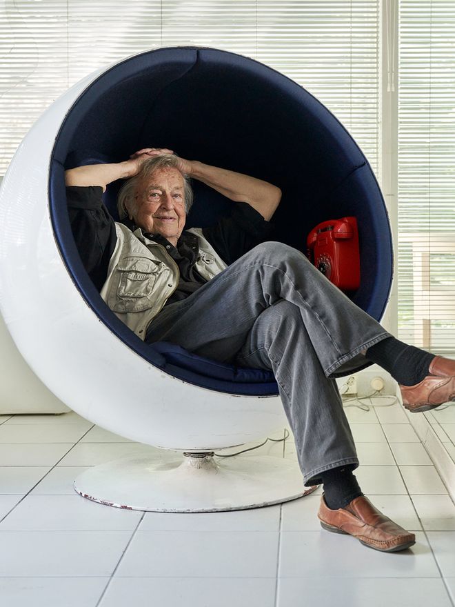 Eero Aarnio sitting in a Ball Chair