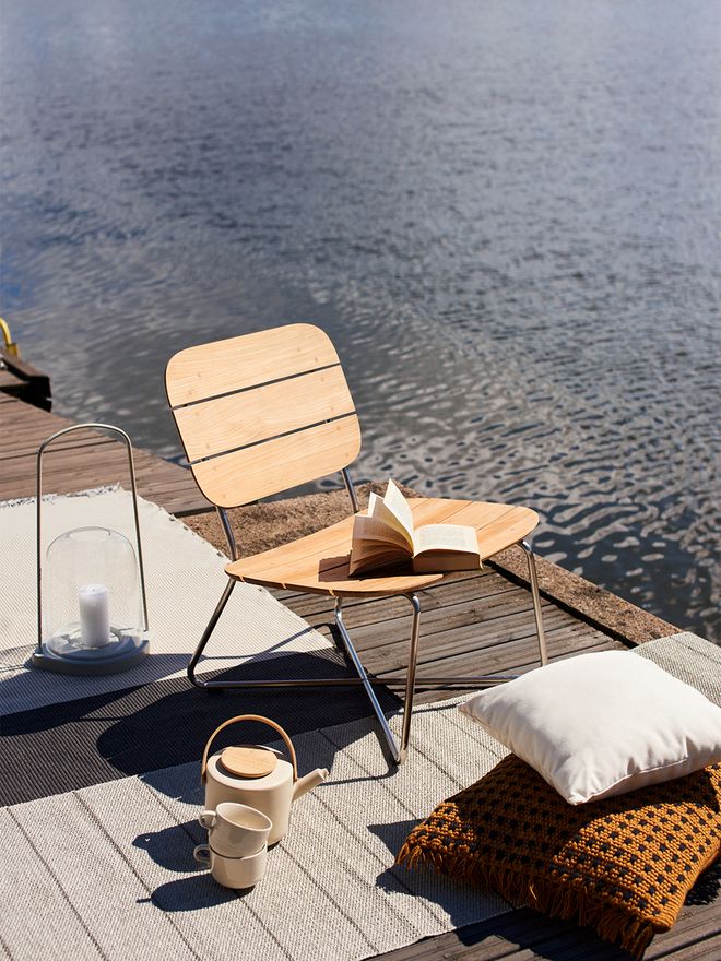 Skagerak's Lilium lounge chair on a pier.