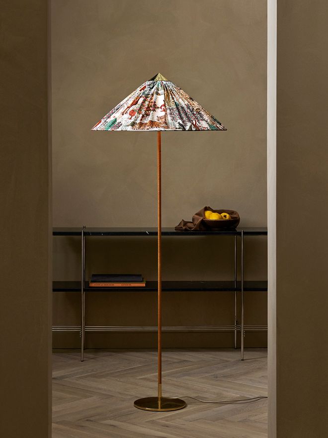 An image featuring GUBI's Paavo Tynell's 9602 floor lamp as part of the living room interior.