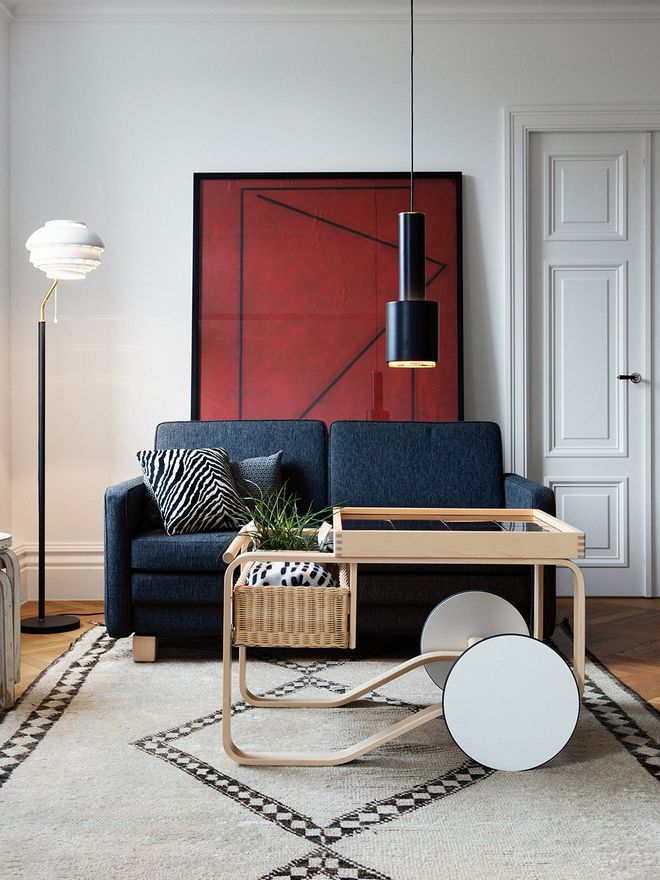 Alvar Aalto's designs A110, A808 and the Tea trolley in a living room setting.