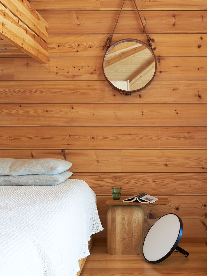 A corner of the cabin interior, with a small Nikari table and a floor lamp by De Padova.