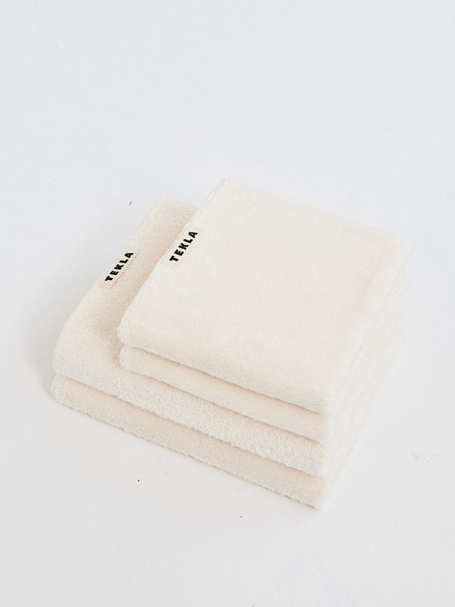 Tekla's broken white towels stacked neatly.