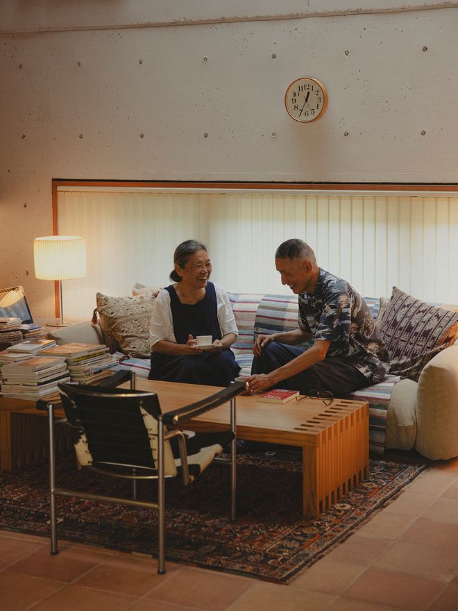 Older Japanese couple sitting on a sofa and chatting
