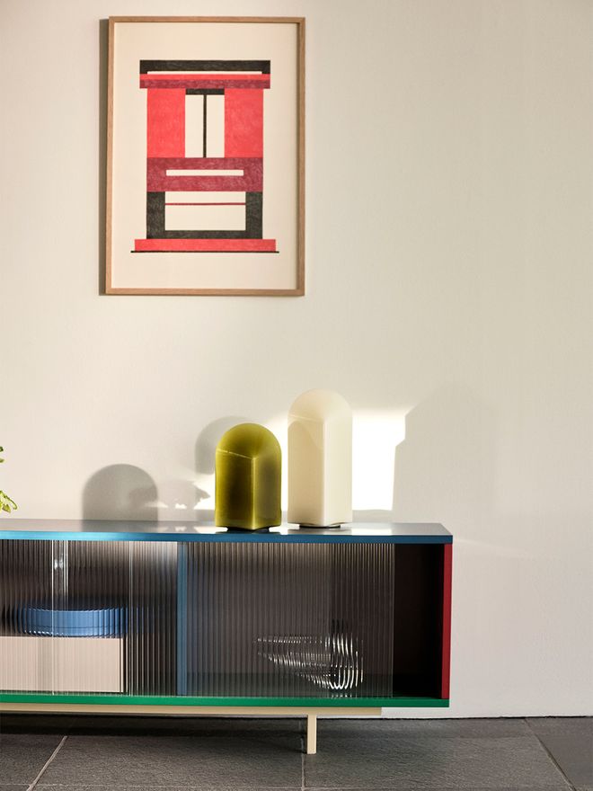 An image featuring HAY's Parade table lamps in two colours on HAY's Colour Cabinet , as part of the living room decor.