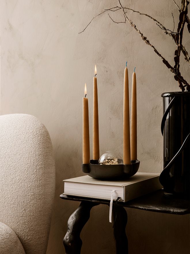 An image with ferm LIVING's Flora glass ornament and Bowl candleholder with candles, as part of a festive holiday decor.