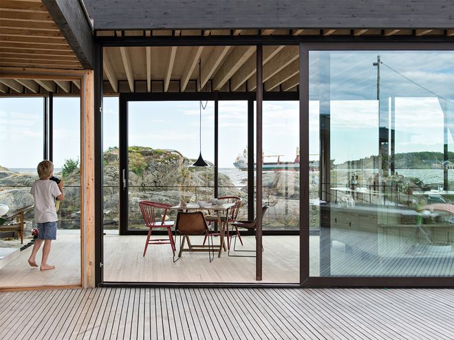 An image of Lille Arøya: dining room decor and patio.