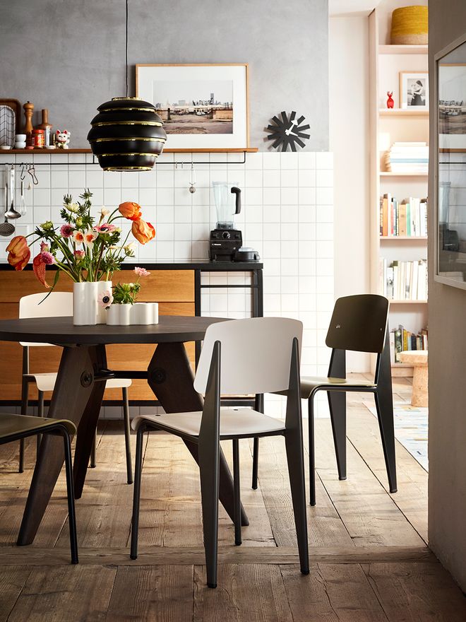 Vitra's Standard chairs, designed by Jean Prouvé, gathered around a dining table