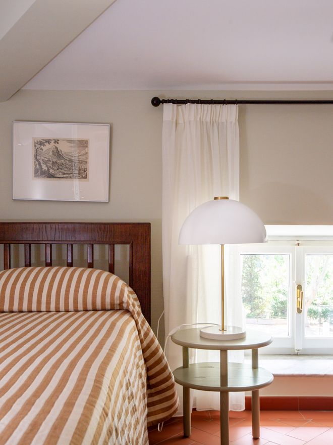 Villa Lante guest room interior with a bed and bedside table