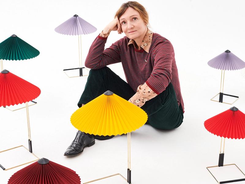 Inga Sempé posing with colorful pleated Matin table lamps by HAY