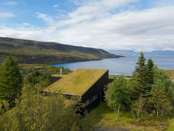 An image of the Holiday home by Þingvallavatn by KRADS architects: a leisure home located in Iceland in the middle of a picturesque scenery. This image features the building as viewed from the outside.