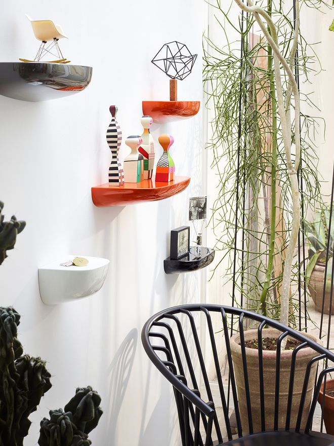 Vitra's wooden dolls on a wall shelf