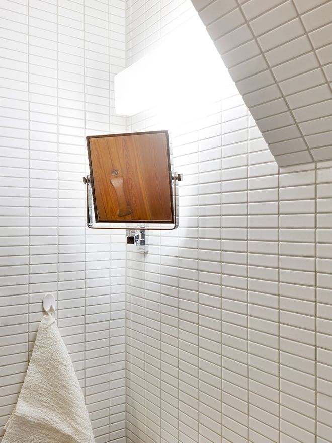 White mosaic tiles in a bathroom.