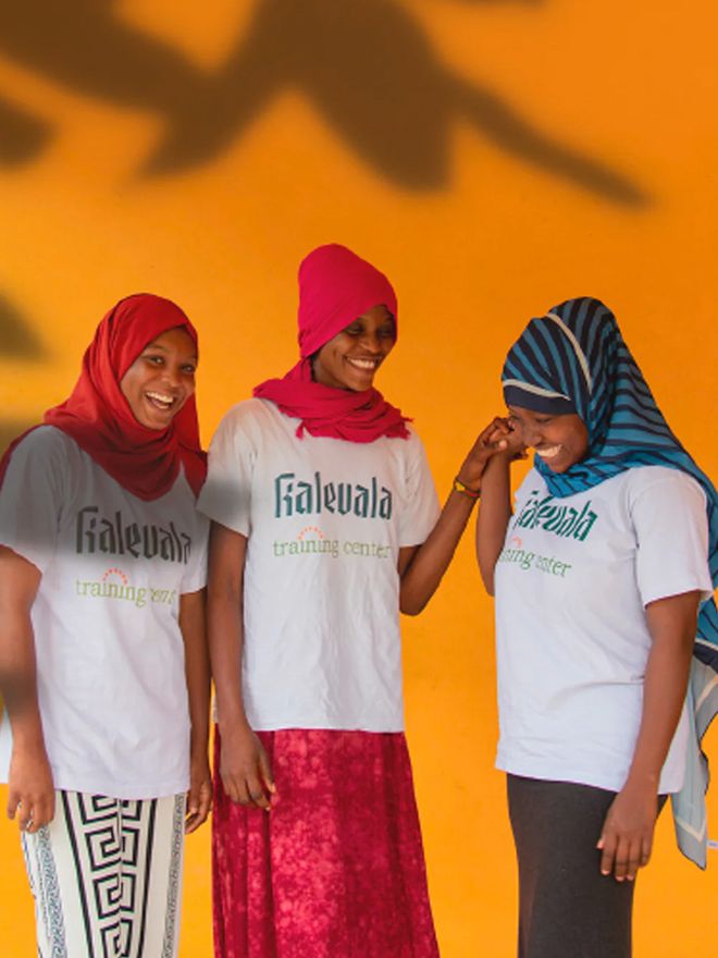 Colourfully dressed, smiling young Kenyan women.