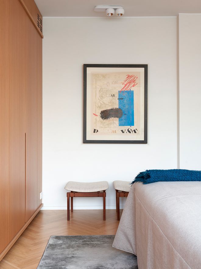 A bedroom with an artwork on the wall