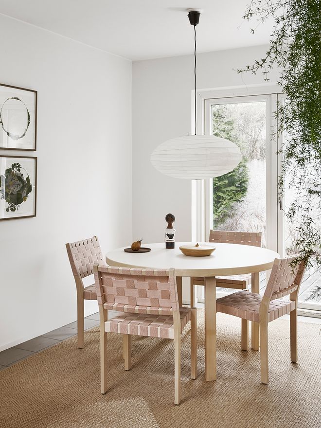 Artek's 611 chairs around a dining table.