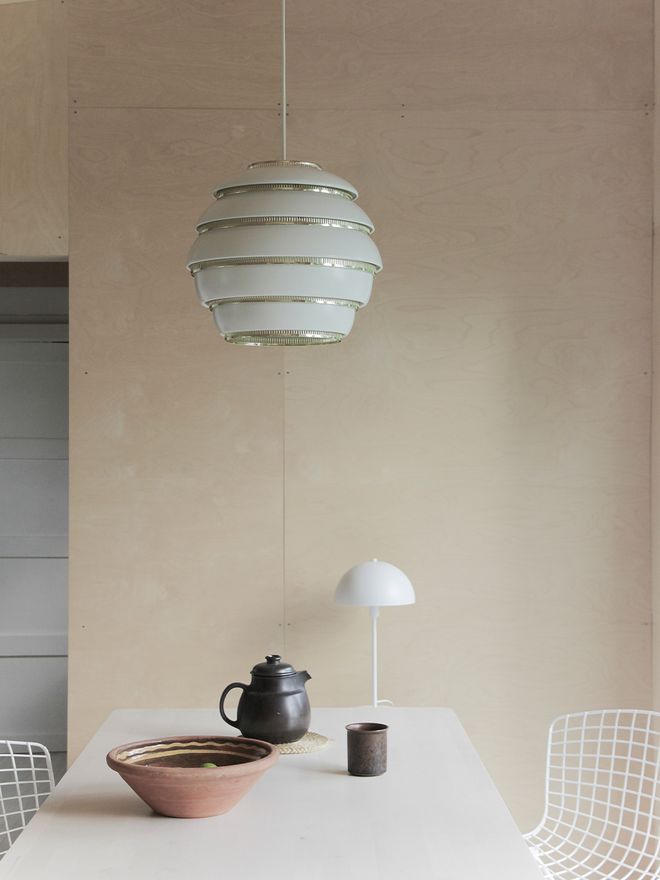 An image featuring Artek's Beehive pendant as part of the dining area interior.