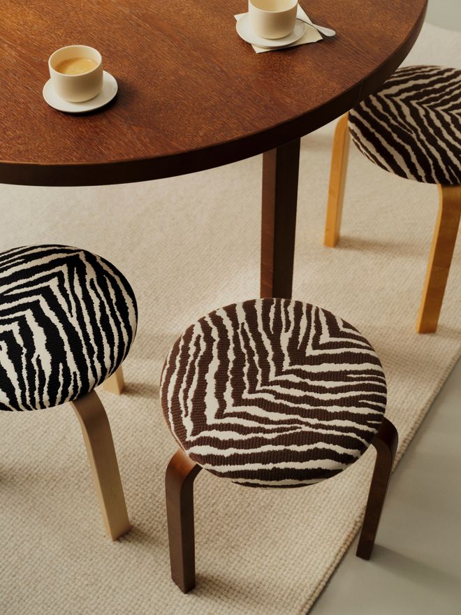 Stools decorated with Artek's Zebra stripe pattern, both in brown-and-white and black-and-white versions