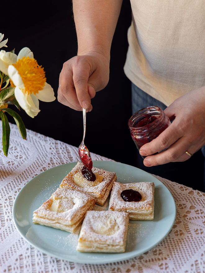 Adding cherry jam to a pastry