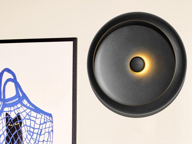 Close-up a Fatboy Oloha portable lamp on a wall.