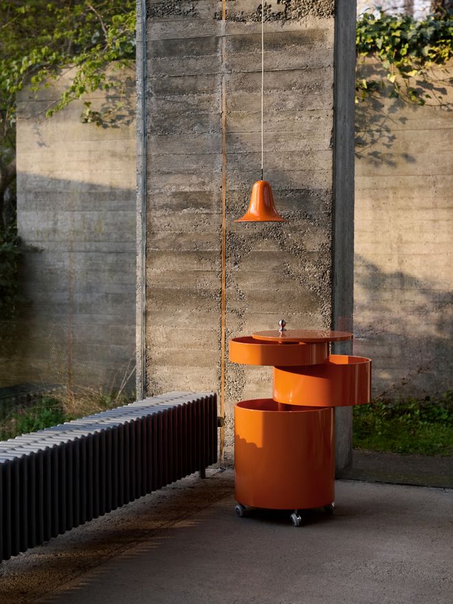 Pantop pendant lamp and Barboy serving trolley designed by Verner Panton in a modern, concrete brutalist space