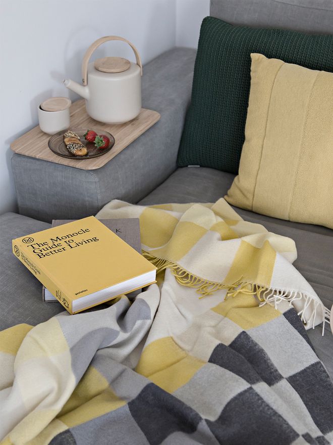 Silkeborg Uldspinderie's All Yellow throw on a sofa.