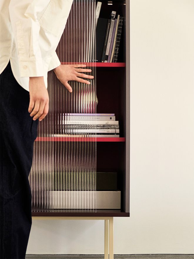 HAY Colour Cabinet wit a person on the left sliding the cabinet's door open