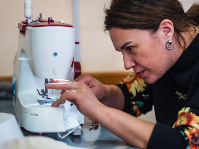 A woman working on a sewing machine