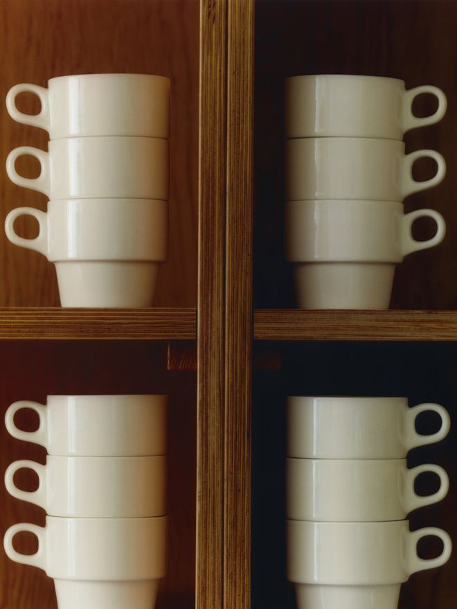 Close-up of Service Projects’ Cafeteria mugs stacked on top of each other