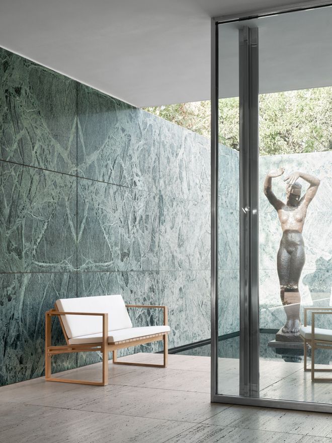 Teak outdoor sofa in a luxurious room with marble walls